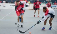  ?? — Reuters ?? Djokovic battles for the ball with Felix Auger of Canada (right) during the Rogers Cup Sportsnet Ball Hockey Challenge.