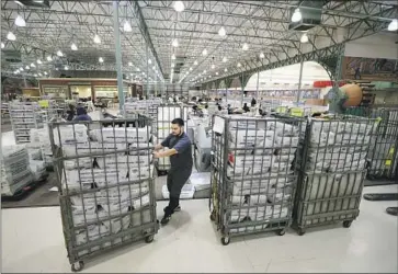  ?? Robert Gauthier Los Angeles Times ?? BALLOTS are received, sorted and verified at a Los Angeles County processing center in the City of Industry. They are then trucked to another facility in Downey to be counted. The tally is updated Tuesdays and Fridays.