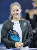  ??  ?? PAVEL GOLOVKIN/AP Daria Kasatkina of Russia poses for a photo during the victory ceremony after the final match of the Kremlin Cup tennis tournament in Moscow, Russia, on October 21, 2017.