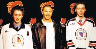  ?? COURTESY TERRY AND KAREN JOHNSON ?? Jarome Iginla poses with twin brothers Curtis Johnson, left, and current Flames goalie Chad Johnson, in their bantam triple-A days in Calgary. Chad would later play with Iginla in Boston.