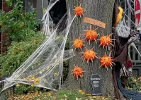  ?? GETTY IMAGES ?? Pumpkins and carrots along with a tombstone help create a public health message about measles and vaccinatio­ns as part of a yard decorated for Halloween in the East End in Toronto, Canada.