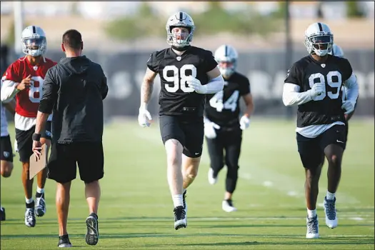  ?? PHOTOS BY STEVE MARCUS ?? Defensive end Maxx Crosby (98) runs during a mini-camp workout June 15 at the Raiders facility in Henderson. As training camp opens ahead of the NFL season, Crosby isn’t making any bold prediction­s about the Raiders. “It sounds cliché to say this year is going to be different, so there’s nothing I really have to say. I just want everyone to tune in and see.”