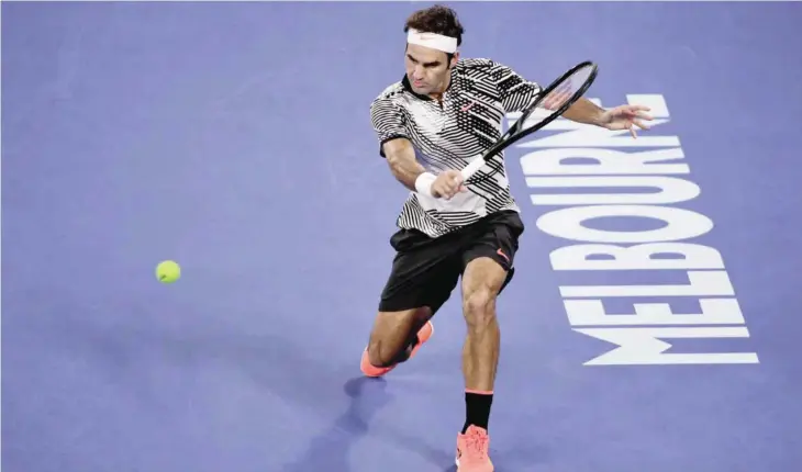  ?? — AFP ?? MELBOURNE: Switzerlan­d’s Roger Federer hits a return against Czech Republic’s Tomas Berdych during their men’s singles third round match on day five of the Australian Open tennis tournament.