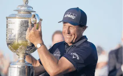  ?? DAVID J. PHILLIP/AP ?? Phil Mickelson holds the Wanamaker Trophy after winning the PGA Championsh­ip on May 23 in Kiawah Island, S.C.