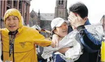  ?? WINSLOW TOWNSON/ THE ASSOCIATED PRESS ?? An unidentifi­ed Boston Marathon runner, centre, is reunited with loved ones following explosions at the Boston Marathon.