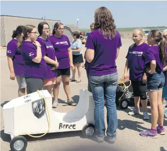  ??  ?? The Girls Exploring Trades and Technology camp prepares to race go-karts that teams of two built on Friday.