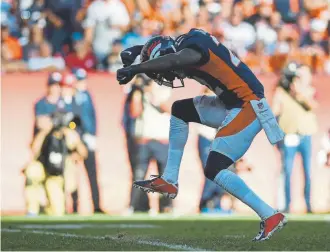  ?? AAron Ontiveroz, The Denver Post ?? Broncos safety Kareem Jackson celebrates after stopping Titans running Derrick Henry during the third quarter.