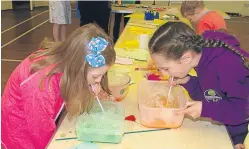  ??  ?? Abigail Irvine Hood, left, and Cara Dingwall blowing bubbles.