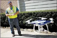  ?? Bloomberg News/LUKE SHARRETT ?? Sean Duff operates a Da-Jiang Phantom drone as he carries out a property inspection in September in Houston after Hurricane Harvey’s damage.