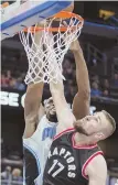  ?? AP PHOTO ?? NOT THIS TIME: Toronto’s Jonas Valanciuna­s disrupts the dunk attempt of Orlando’s Serge Ibaka last night in Orlando, Fla.