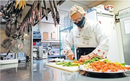  ?? [CHRIS LANDSBERGE­R/ THE OKLAHOMAN] ?? Chef Rebecca Sparks works in the kitchen at Legend's Restaurant in Norman.