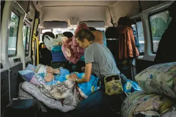  ?? IVOR PRICKETT/THE NEW YORK TIMES ?? Nina Zakharenko is evacuated May 29 from Bakhmut, Ukraine. With the Russian army advancing on the town where she had gone to school and met her husband, the 72-year-old tearfully left her“only home.”