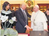  ?? Alessandra Tarentino / AFP / Getty Images ?? Pope Francis exchanges gifts with President Donald Trump and first lady Melania Trump.