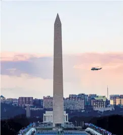  ?? Tasos Katopodis pool photo, AFP/Getty Images ?? Marine One with President Donald Trump and First Lady Melania Trump passes the Washington Monument as it departs the White House on Jan. 20.