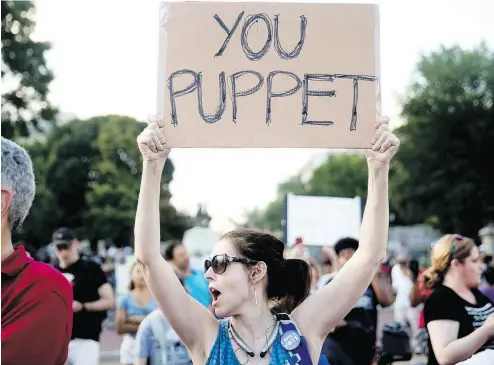  ?? ANDREW HARNIK / THE ASSOCIATED PRESS ?? A woman holds a sign that reads “You Puppet” during a demonstrat­ion outside the White House to protest President Donald Trump’s meetings in Helsinki with Russian President Vladimir Putin.