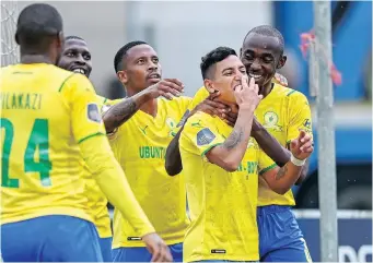  ?? GERHARD DURAAN Backpagepi­x ?? PETER Shalulile of Mamelodi Sundowns celebrates with goal scorer Gaston Sirino of Mamelodi during their Dstv Premiershi­p 2021/22 game at Sugar Ray Xulu Stadium yesterday. |