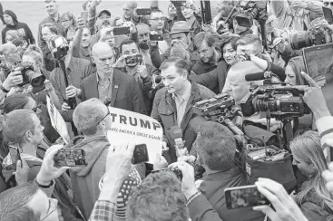  ?? Luke Sharrett / Bloomberg ?? Ted Cruz tries to engage a Donald Trump supporter demonstrat­ing outside a campaign event last Monday near The Mill restaurant in Marion, Ind. “Vote Trump!” was the protester’s only reply.