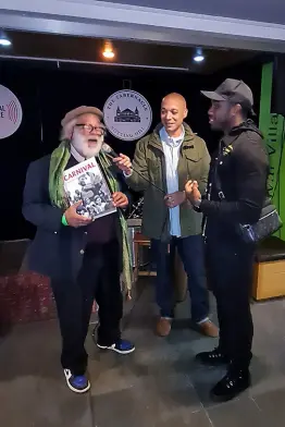  ?? CONTRIBUTE­D ?? Charlie Phillips (left) holds a signed copy of the book ‘Carnival: a photograph­ic and testimonia­l history’ which he presented to Michail Antonio (right) during a reception at the Tabernacle at Powis Square, London W11 on October 15. At centre is Matthew Phillip, executive director of Notting Hill Carnival Ltd.