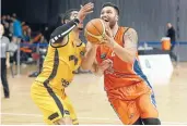  ?? Photo: ROBYN EDIE/FAIRFAX NZ 630962859 ?? Sharks player James Paringatai heads for the hoop under pressure from Taranaki’s Aaron Fuller.