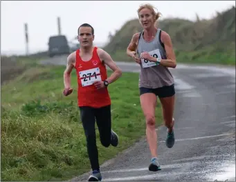  ??  ?? Shane Larkin and former Olympian Catherina McKiernan battling it out at the Annagassan 10K Road Race.