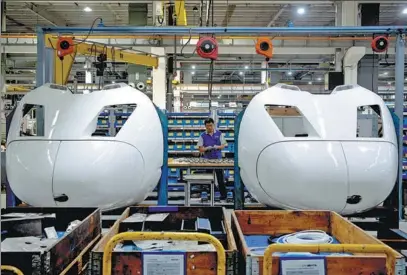  ?? GAO ERQIANG / CHINA DAILY ?? A Voith Turbo employee works on the Shanghai assembly line on Thursday.