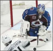  ?? Associated Press ?? STOPPED
Los Angeles Kings left wing Carl Grundstrom, left, fires the puck at Colorado Avalanche goaltender Philipp Grubauer, right, in the first period on Sunday in Denver.