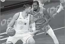  ?? MARY ALTAFFER/AP PHOTO ?? Orlando Magic center Nikola Vucevic (9) drives against Brooklyn Nets forward Kevin Durant (7) during Saturday’s game in New York.