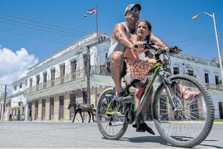  ??  ?? LEFT A man rides his bicycle along the streets of Cardenas, a city 130 kilometres east of Havana.