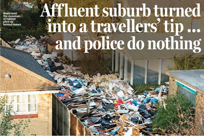  ??  ?? Waste land: The mountain of rubbish piled up behind homes