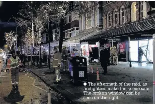  ??  ?? The aftermath of the raid, as firefighte­rs make the scene safe. The broken window can be seen on the right