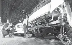  ?? FREEMAN FILE PHOTO ?? A police officer takes pictures of the truck damaged during the explosion in Hilton Motors Corporatio­n display center.