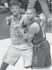  ?? Yi-Chin Lee / Houston Chronicle ?? The Timberwolv­es’ Jimmy Butler, left, apparently doesn’t like the physical defense being applied by Eric Gordon on Sunday.