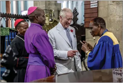  ?? (AP/Luis Tato) ?? Britain’s King Charles III (center) shares a laugh Friday with religious leaders including Bishop of the Anglican Diocese of Mombasa Alphonce Mwaro Baya (second from left) during an interfaith meeting at Mombasa Memorial Cathedral in Mombasa, Kenya, Friday.