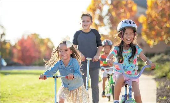 ??  ?? Young residents enjoy a bike ride through the community. Family-friendly homes at The Summit and Eastridge are now available in Rocklin.