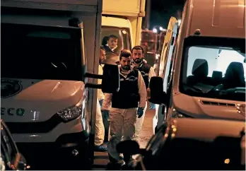  ?? AP ?? Turkish crime scene investigat­ors dressed in coveralls and gloves assemble before entering the Saudi Arabia consulate yesterday, nearly two weeks after the disappeara­nce and alleged slaying of Saudi writer Jamal Khashoggi there.