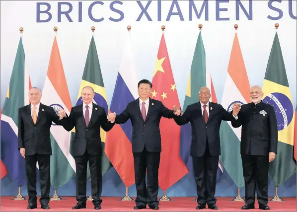  ??  ?? A CLUB OF FRIENDS: From left, Brazil’s President Michel Temer, Russian President Vladimir Putin, Chinese President Xi Jinping, South Africa’s former president Jacob Zuma and Indian Prime Minister Narendra Modi pose for a group photo during the last...