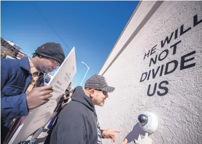  ?? ROBERTO E. ROSALES/JOURNAL ?? Ephraim Colbert, left, of San Francisco and Sylvester Padilla of Albuquerqu­e speak in front of actor Shia LaBeouf’s art installati­on, which is streamed online 24 hours a day.