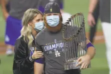  ?? Tom Pennington / Getty Images ?? The Dodgers’ Justin Turner disregarde­d pandemic protocols to celebrate a World Series win with his wife, Kourtney Pogue.