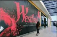  ?? RICHARD VOGEL — ASSOCIATED PRESS ?? A person walks by a new shop being installed at the Westfield Century City Mall in the Century City section of Los Angeles last month.