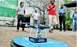  ??  ?? Lahiru Pathmalal (left) during testing of the drone.