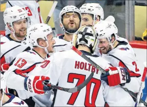  ?? AP PHOTO ?? Washington Capitals goaltender Braden Holtby ( 70) celebrates with Evgeny Kuznetsov ( 92), Jakub Vrana ( 13), Alex Ovechkin, top centre, and Matt Niskanen ( 2) after Kuznetsovs’ game- winning goal during the overtime period in Game 6 of an NHL second-...