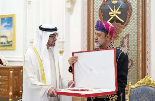  ?? ?? ↑ Sheikh Mohamed receives the Order of Al Said from Sultan Haitham in Muscat on Tuesday.