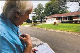  ?? Scott Bauer Associated Press ?? DEMOCRATIC organizer Bill Chandler canvasses homes in Whitewater, Wis., last month. The state is expected to be crucial in the presidenti­al election.