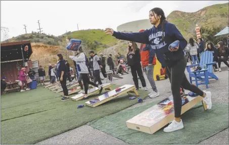  ?? Chris Torres/ The Signal ?? Saugus High School softball outfielder Kennedy Thompson competes in a cornhole event at the Saugus High School Softball Cornhole Fundraiser held at Lucky Luke Brewing in Valencia earlier this month.