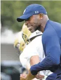  ?? TOMMY GILLIGAN / AP ?? Robert Green, Navy’s third cornerback­s coach in as many seasons, oversees the action while the Midshipmen practice. Green played in the Navy secondary from 1994-96.