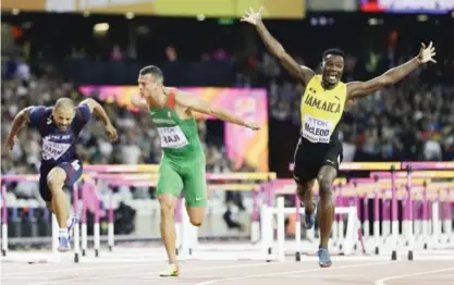  ??  ?? LONDON: Jamaica’s Omar Mcleod, right, celebrates as he wins the gold medal in the final of the Men’s 110m hurdles during the World Athletics Championsh­ips in London Monday at center is Hungary’s Balazs Baji who took the bronze. —AP
