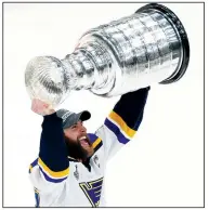  ?? AP/CHARLES KRUPA ?? St. Louis’ Alex Pietrangel­o carries the Stanley Cup on Wednesday after the Blues defeated the Boston Bruins in Game 7 of the NHL Stanley Cup Final in Boston.