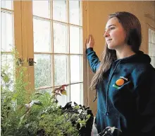  ?? JESSICA NYZNIK EXAMINER ?? Sally Russell poses for a photo in her East City home on Monday after returning from a six-month volunteeri­ng mission in Canada.