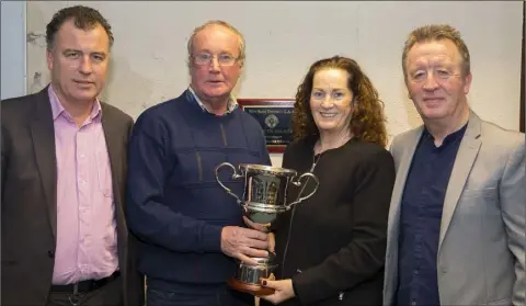  ??  ?? Seamus Cullen receiving the Paddy Kehoe Perpetual Memorial Trophy for Gusserane G.A.A. clubperson of the year from Paddy’s daughter, Julie, accompanie­d by her husband, Jackie Roche (right), as club Chairman Cllr. Michael Whelan looks on.