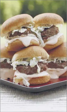  ??  ?? JUSTIN FOX BURKS A simple Buffalo-style dressing of mayonnaise mixed with hot sauce and tossed with coleslaw rounds out the Buffalo wing experience on these sliders. Serve them at a picnic, a backyard cookout or a tailgate party.